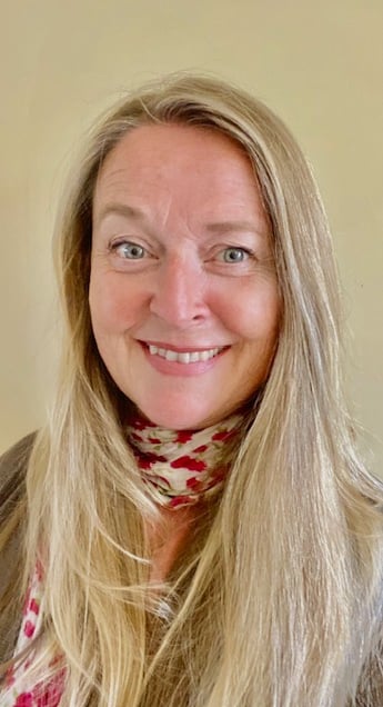 A photo of Dr Siobhan henley smiling wearing pink scarf