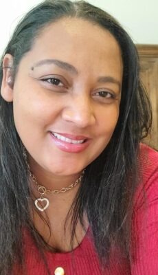 a woman in a red sweater and a necklace