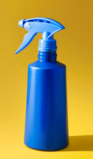 a blue spray bottle on a yellow background