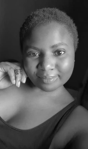 a woman with a hand on her jaw smiling at he camera