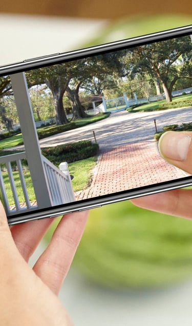 a person taking a picture of a house with a camera