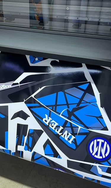 Custom blue and black vinyl graphics for a vehicle being printed on a large format plotter.