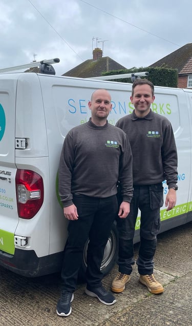 two men standing next to a van with a van in the background