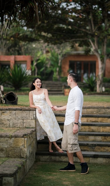 Intimate couple interacting on garden steps at Waka Gangga luxury resort in Tabanan Bali