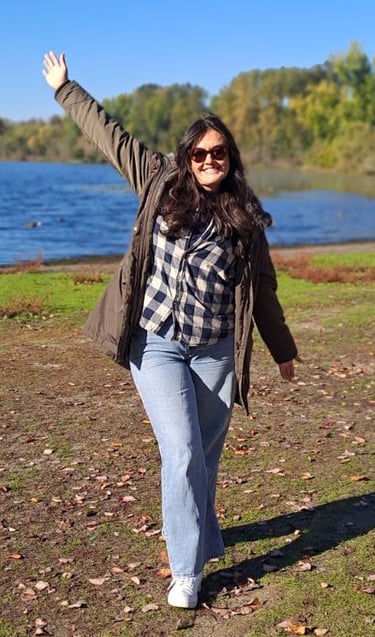 a woman standing in front of a lake