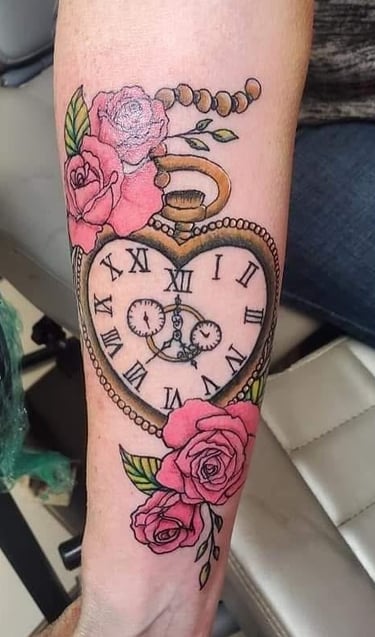 a clock on a wrist tattoo of a heart shaped clock