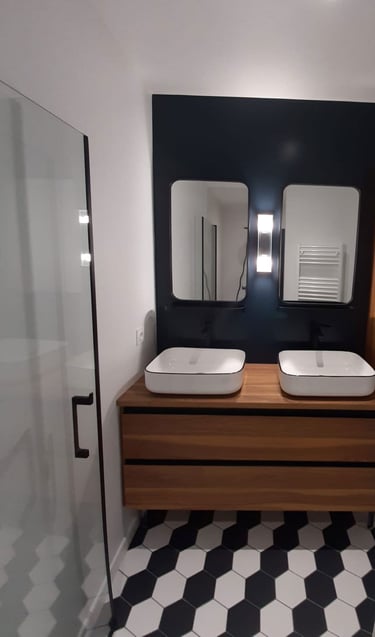 a bathroom with two sinks and a shower