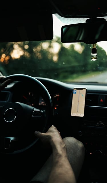 a person is driving a car with a gps device