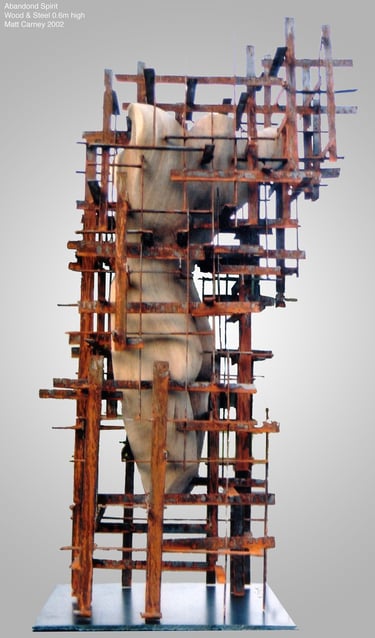 Sculpture of a woman's torso carved in wood inside a rusted steel grid