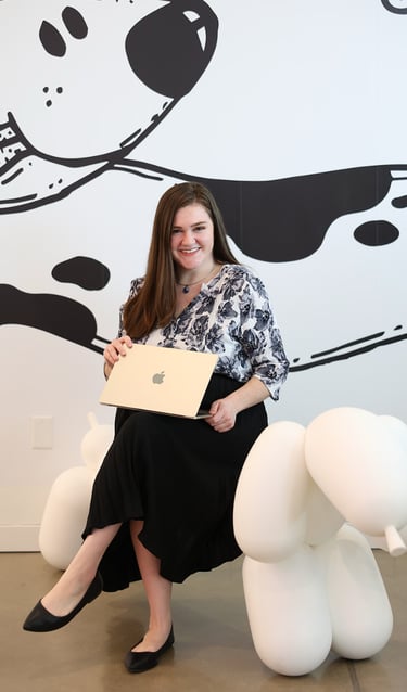 Marissa Wright with her laptop sitting on a giant baloon chair