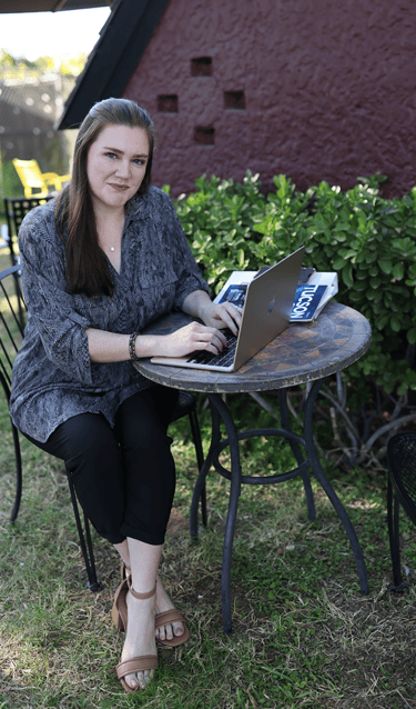 Marissa Wright of Sage & Craft Media with laptop