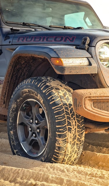a jeep wrangling a jeep with a red and black lettering on it