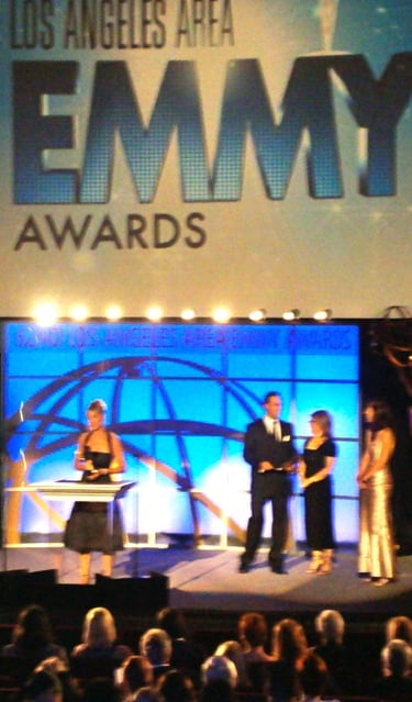 Angie Crouch accepts Emmy Award on stage in Los Angeles
