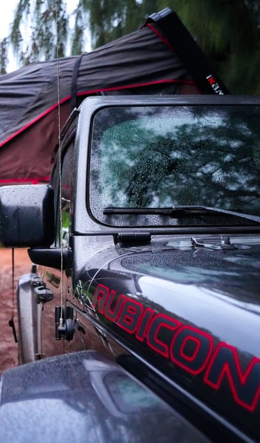 a black and red jeep with a black tent