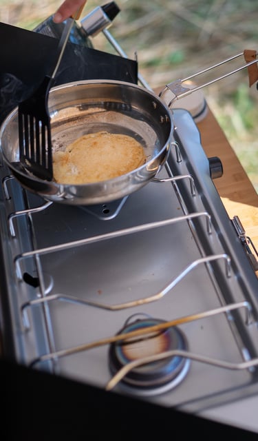 Cooking pancakes on a camp stove