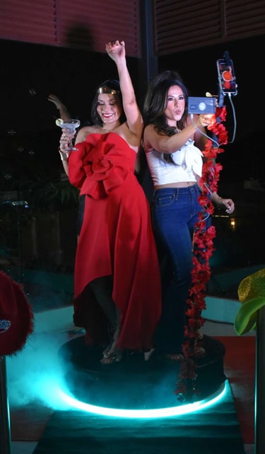 two women standing on a stage with a microphone