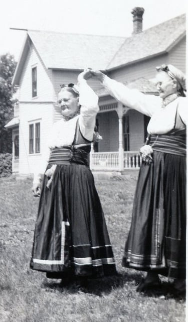 two women in bunad dancing, black and white