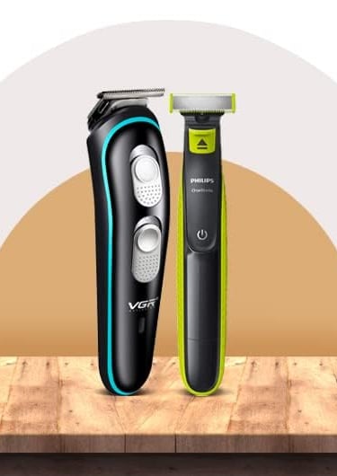 Professional VGR beard trimmer and Philips OneBlade electric shaver displayed on a wooden surface.