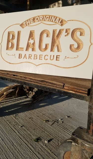 a custom made wooden sign that says black's barbequequee