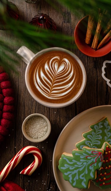 a cup of coffee and cookies on a table