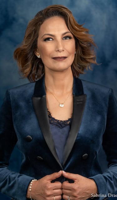 a corporate woman in a blue jacket and a necklace