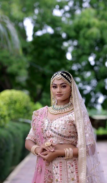 Beautiful bride in pink bridal lehenga with floral embroidery, modern bridal makeup, and heavy 