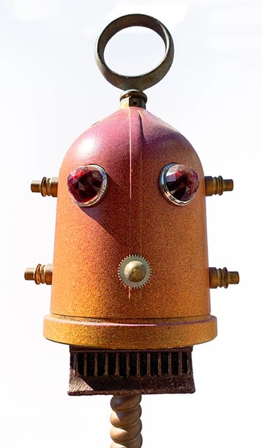 Orange found object robot head by sculptor Tal Avitzur.