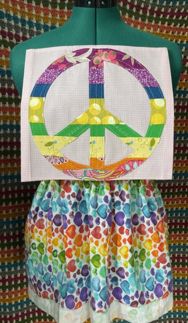 square Peace Flag rainbow peace sign sewn onto white and pink fabric