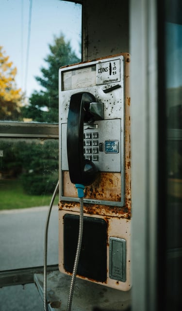 a phone booth with a phone and a telephone booth