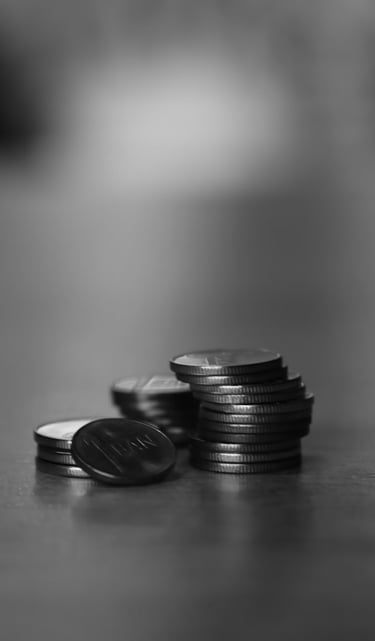 Three piles of coins on a table.