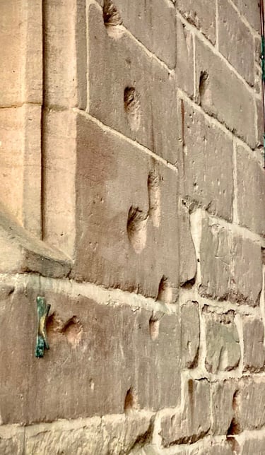 photograph showing musket damage to a stone wall.