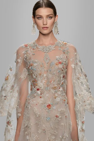 a model in a dress made by Embroidered and Beaded Lace Fabrics 