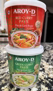 tubs of Aroy-D red and green curry paste