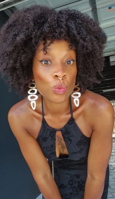 in oso a woman with a large afro - colored hair and piercings