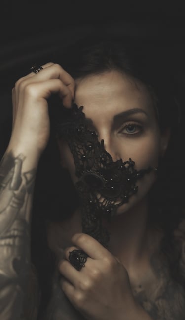 a woman with tattoos on her face and a black mask