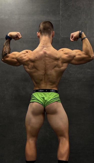 a man in a green underwearsuit with a muscular body