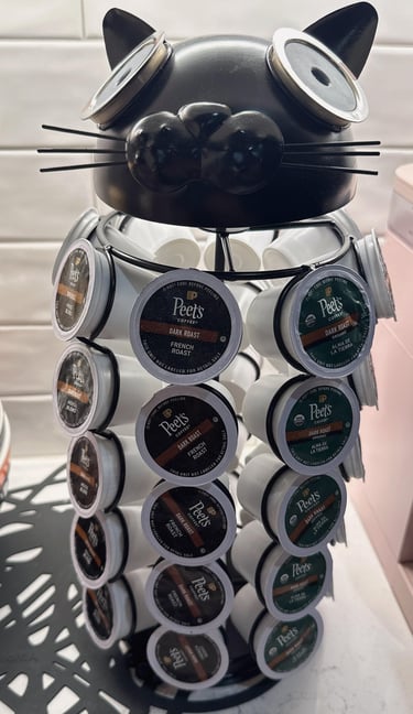 Black cat shaped coffee pod holder filled with assorted Peet's Coffee dark roast K-Cup capsules.