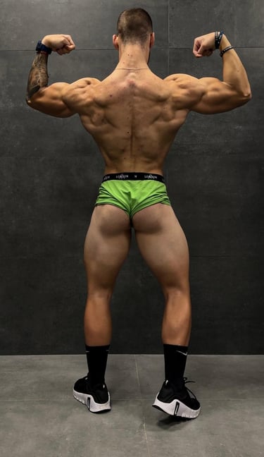 a man in a green underwearsuit with a muscular body
