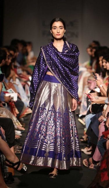 A model doing a ramp walk in a dress made from handloom fabric