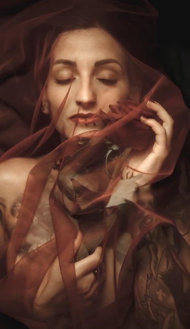 photo of a woman in a red dress with a veil on her head holding a rose