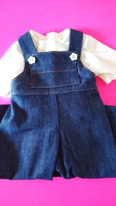 Handmade denim overalls and white T-shirt set for 18-inch dolls, displayed on a bright pink backgrou