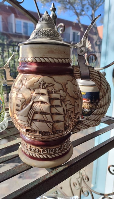 a beer stein with a ship on it