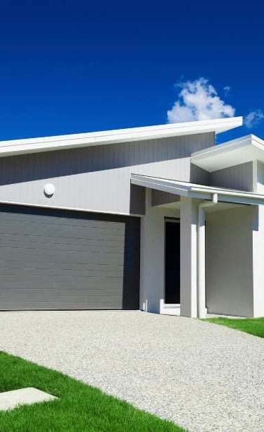 a house with a garage door and a driveway