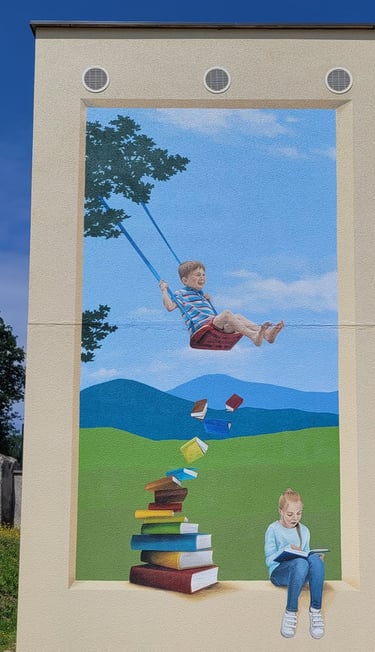 Fresque sur façade. Comme une ouverture dans un mur avec fond paysagé où des enfants jouent. 