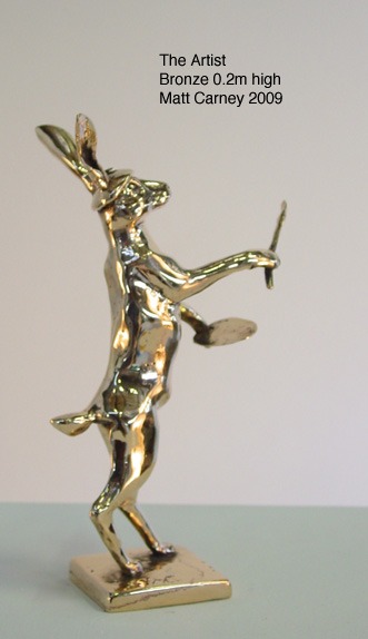 a sculpture of a rabbit with a paintbrush and palette