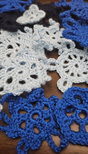 crochet snowflakes on a wooden table