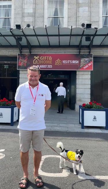 John + Jack the dog standing in doppler gear at the door of the RDS in Dublin for Gift & Home