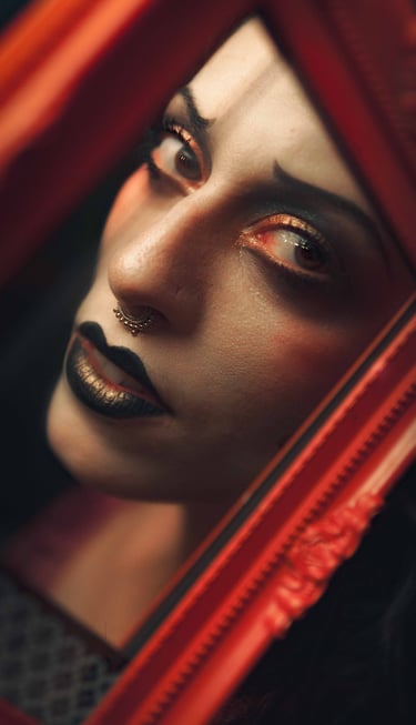 a cabaret performer with black makeup and a black lip LOOKING IN A RED MIROr