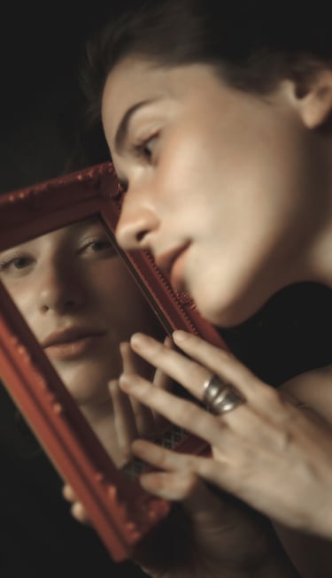 a woman is looking at her reflection in a mirror