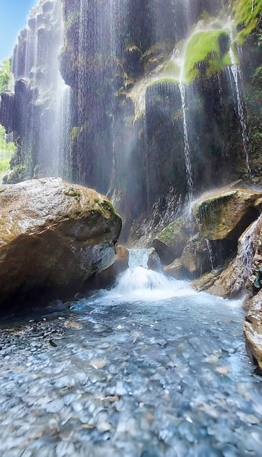 Umbrella waterfall in a canyon with a waterfall in the background